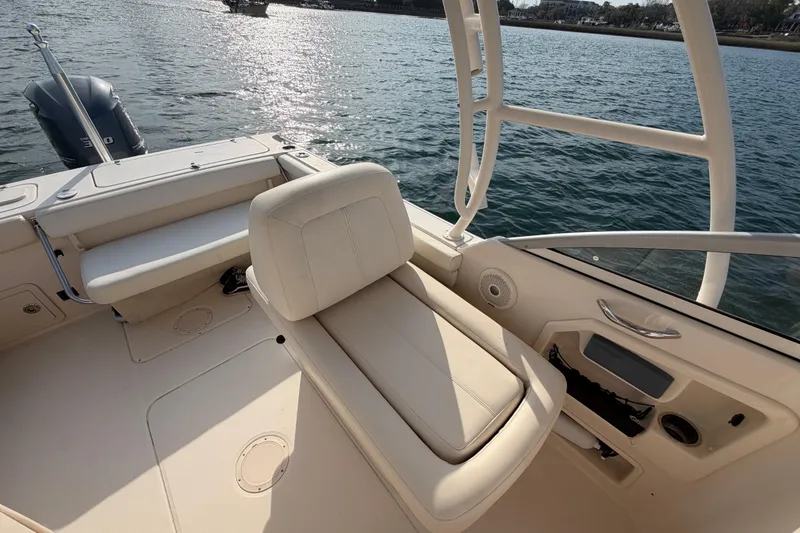 Slide: The Image of 2017 Grady-White Freedom 225 boat interior with seating, on calm water. - 26