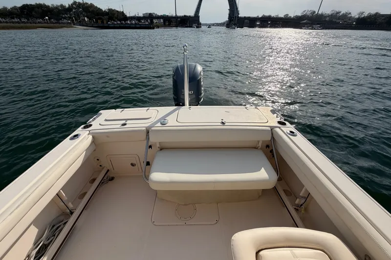 Slide: The Image of 2017 Grady-White Freedom 225 boat interior with seating, on calm water. - 29