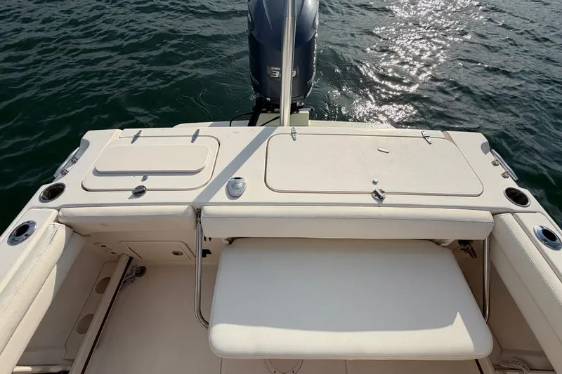 Slide: The Image of 2017 Grady-White Freedom 225 boat deck with seating and storage, on water. - 30