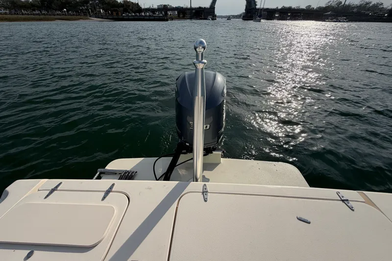 Slide: The Image of 2017 Grady-White Freedom 225 boat on water, with open bridge in background. - 32