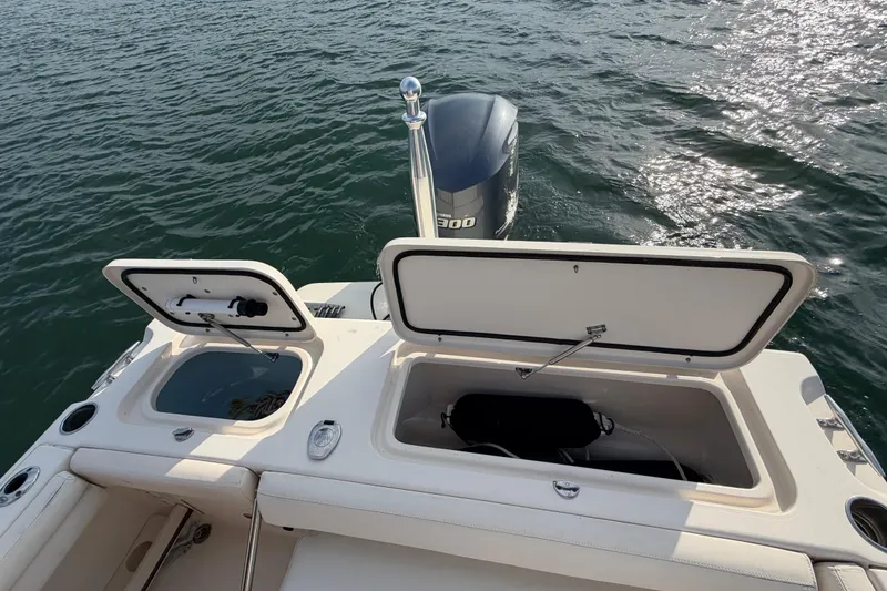 Slide: The Image of 2017 Grady-White Freedom 225 boat with open storage compartments on water. - 34