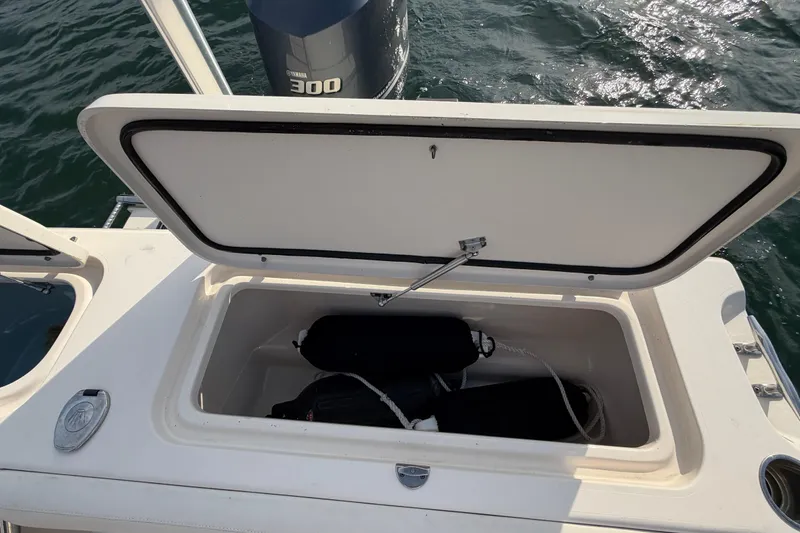 Slide: The Image of Open storage compartment on 2017 Grady-White Freedom 225 boat, with Yamaha 300 engine visible. - 35