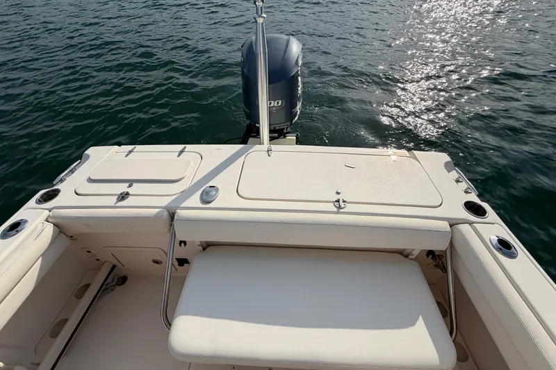 Slide: The Image of 2017 Grady-White Freedom 225 boat stern view with outboard motor on water. - 36