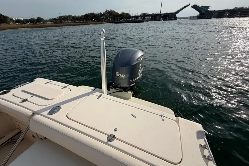 Slide: The Image of 2017 Grady-White Freedom 225 boat with outboard motor on open water near drawbridge. - 38