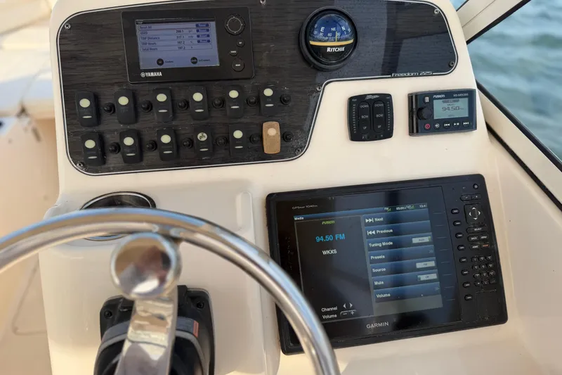 Slide: The Image of Control panel of 2017 Grady-White Freedom 225 boat with navigation and audio systems. - 39