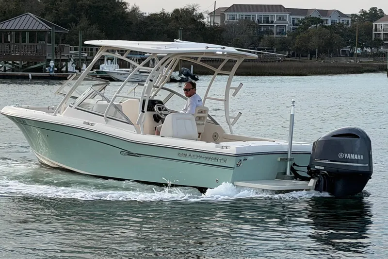 Slide: The Image of 2017 Grady-White Freedom 225 boat cruising on water with Yamaha outboard motor. - 4