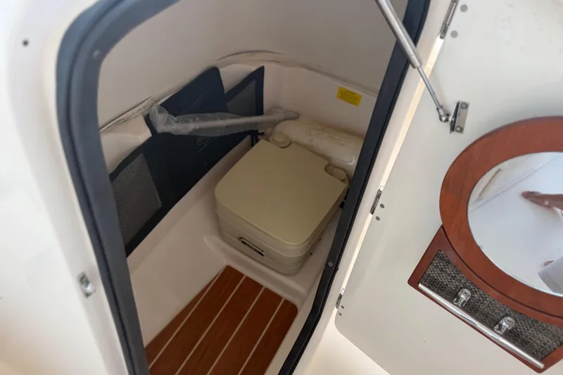Slide: The Image of Interior of 2017 Grady-White Freedom 225 boat with compact toilet and wooden flooring. - 42