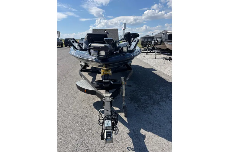 Slide: The Image of 2020 Triton 189 TrX boat on trailer under a clear blue sky. - 13