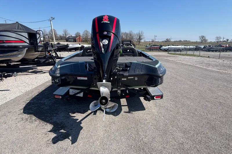 Slide: The Image of 2020 Triton 189 TrX boat with powerful outboard motor in a parking lot. - 2