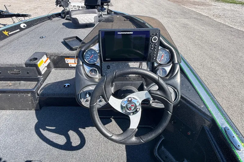 Slide: The Image of 2020 Triton 189 TrX boat dashboard with steering wheel and Humminbird display. - 6