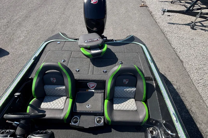 Slide: The Image of 2020 Triton 189 TrX boat interior with green-accented seats and steering wheel. - 9