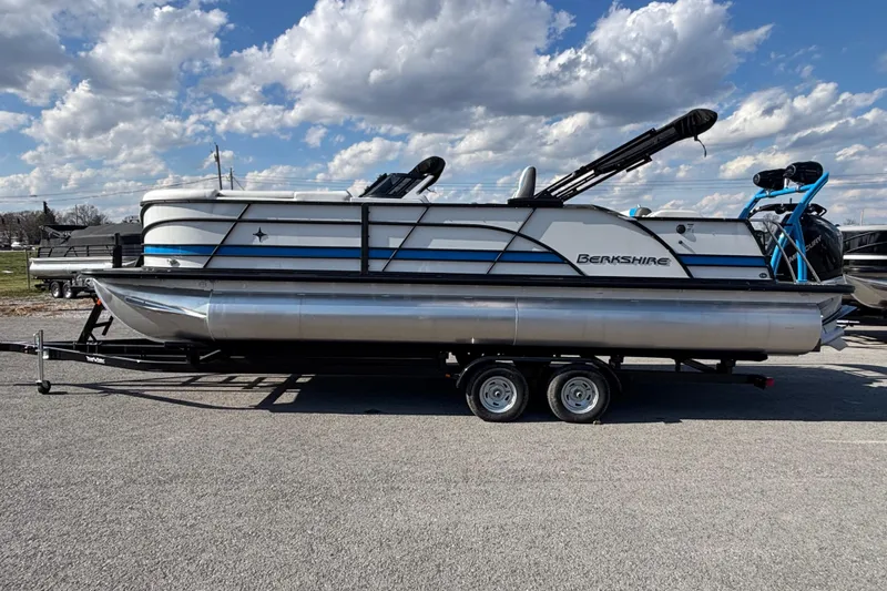 The Image of 2025 Berkshire 25UL DC STS pontoon boat on trailer under cloudy sky. - 1