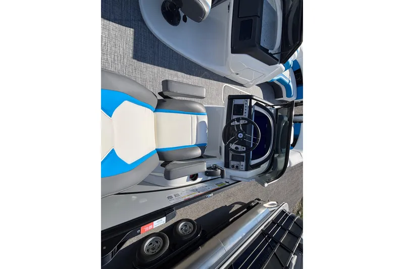 Slide: The Image of 2025 Berkshire 25UL DC STS boat interior with modern steering console and seating. - 8