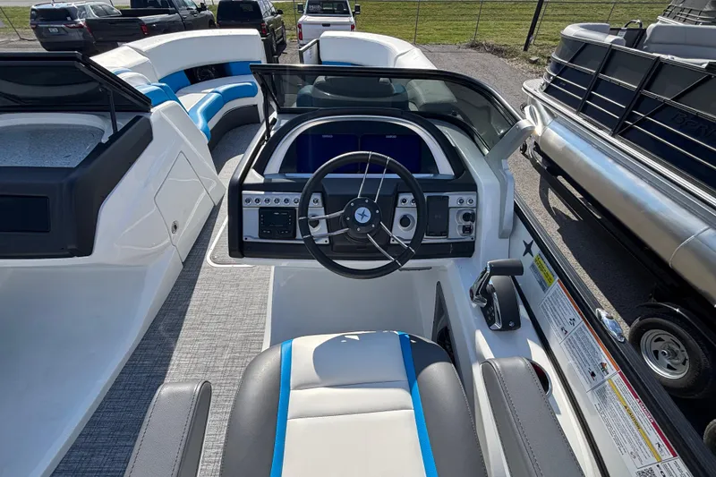 Slide: The Image of 2025 Berkshire 25UL DC STS boat interior with modern steering console and seating. - 9