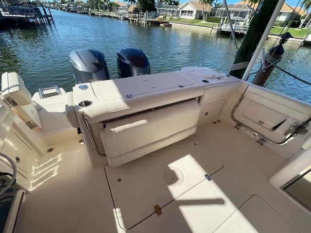 Slide: The Image of Grady-White 325 Freedom 2021 boat on water with twin outboard engines. - 20