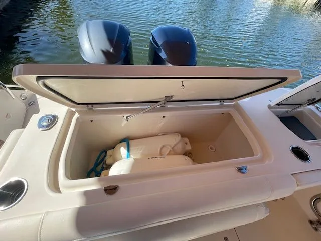 Slide: The Image of 2021 Grady-White 325 Freedom with open storage compartment and engines. - 22