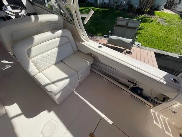 Slide: The Image of Interior of a 2021 Grady-White 325 Freedom boat with beige seating area. - 27
