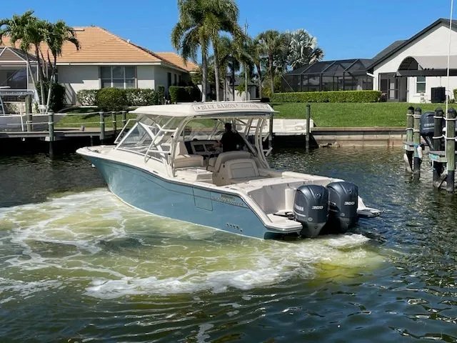 Slide: The Image of Grady-White 325 Freedom 2021 boat on water, sunny day. - 4