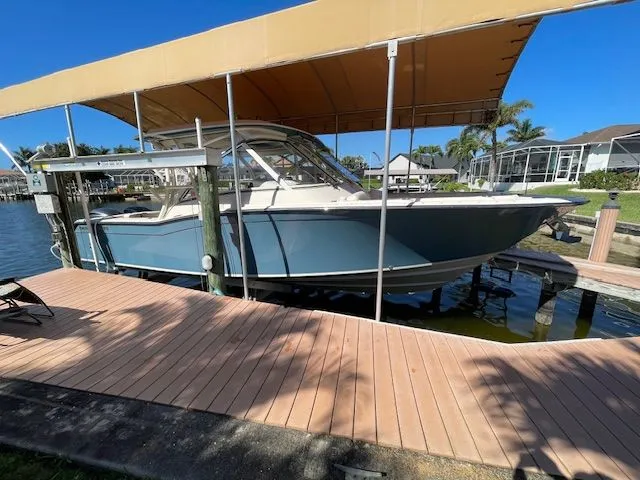 Slide: The Image of 2021 Grady-White 325 Freedom boat under dock canopy. - 7