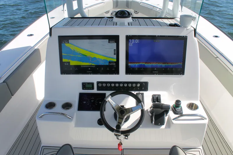 Slide: The Image of 2024 Cape Horn 39 T boat dashboard with dual navigation screens and steering wheel. - 14