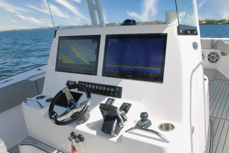 Slide: The Image of 2024 Cape Horn 39 T boat dashboard with dual Garmin displays on open water. - 15