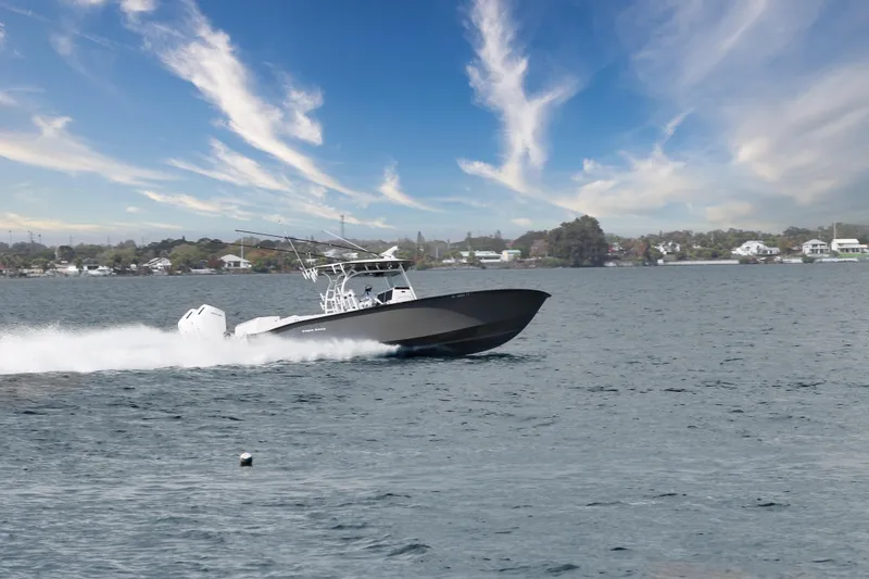 Slide: The Image of 2024 Cape Horn 39 T boat cruising on a scenic waterway under a blue sky. - 36