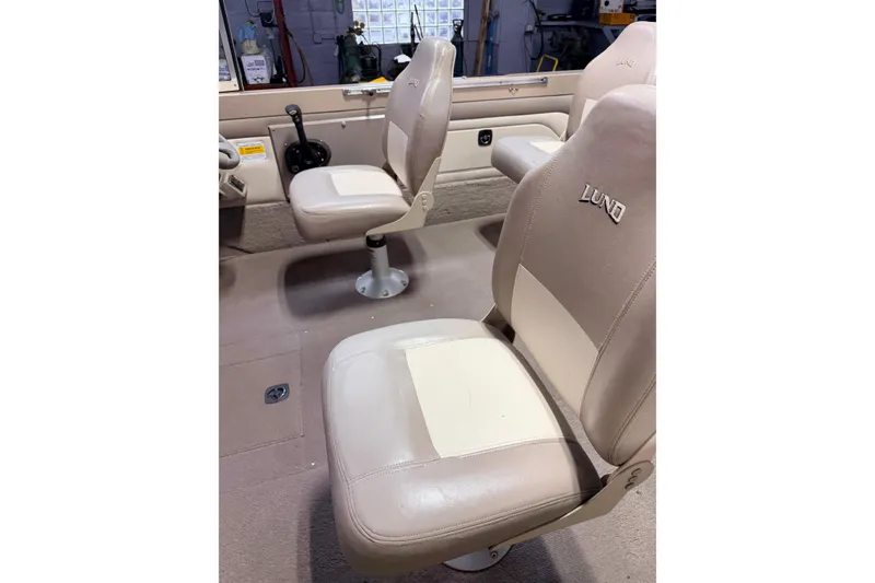 Slide: The Image of Dashboard of a 2000 Lund 1850 Tyee Gran Sport boat with steering wheel and gauges. - 16