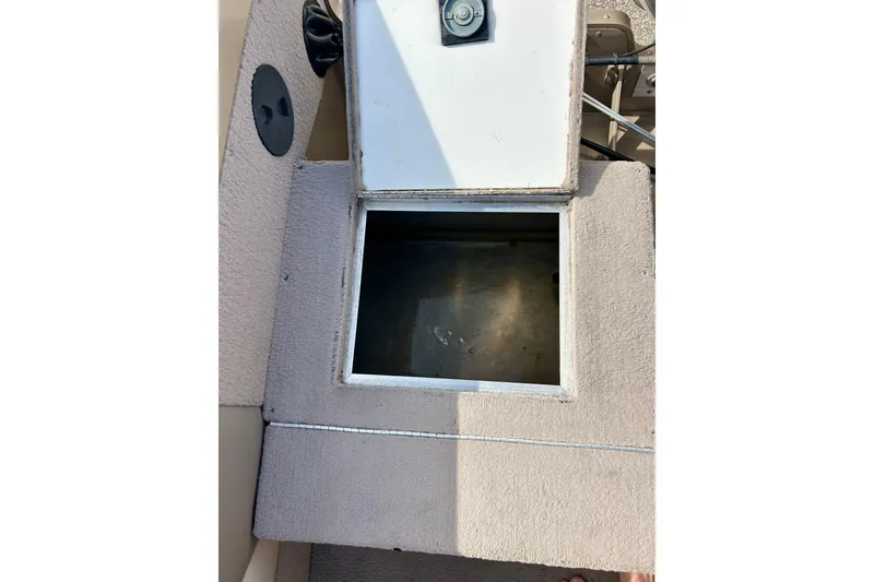 Slide: The Image of Open storage compartment on a 2000 Lund 1850 Tyee Gran Sport boat. - 25