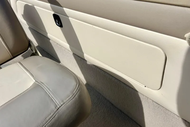 Slide: The Image of Interior of 2000 Lund 1850 Tyee Gran Sport boat, featuring beige seating and paneling. - 29