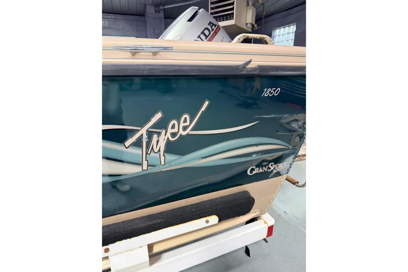 Slide: The Image of Trailer wheel of 2000 Lund 1850 Tyee Gran Sport on gravel surface. - 3