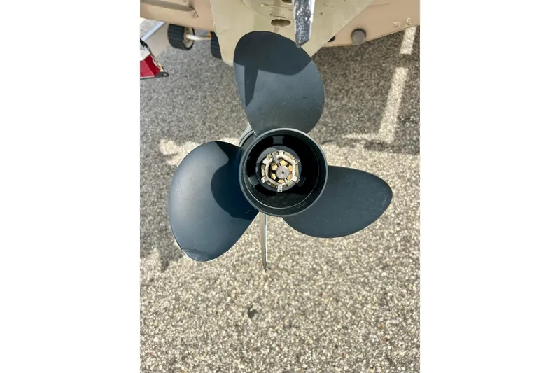 Slide: The Image of Propeller of 2000 Lund 1850 Tyee Gran Sport boat on pavement background. - 34