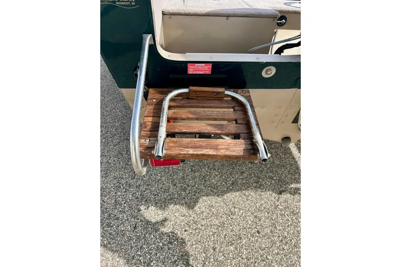 Slide: The Image of Lund 1850 Tyee Gran Sport 2000 with wooden platform and metal railing. - 35