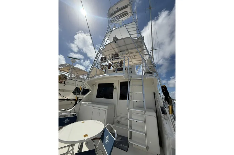 Slide: The Image of 1988 Bertram 43 Flybridge yacht with ladder and seating under a sunny sky. - 19