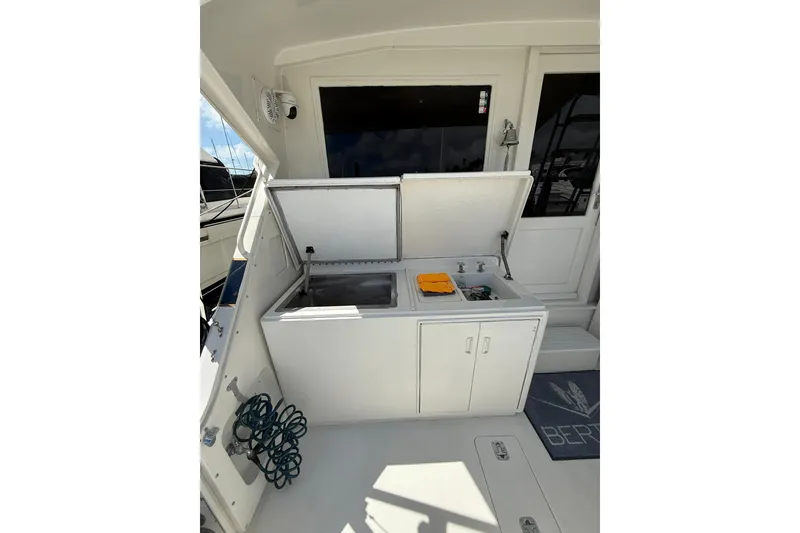 Slide: The Image of 1988 Bertram 43 Flybridge yacht with outdoor sink and storage area. - 22