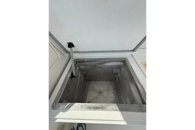 Slide: The Image of Open storage compartment on 1988 Bertram 43 Flybridge boat. - 23