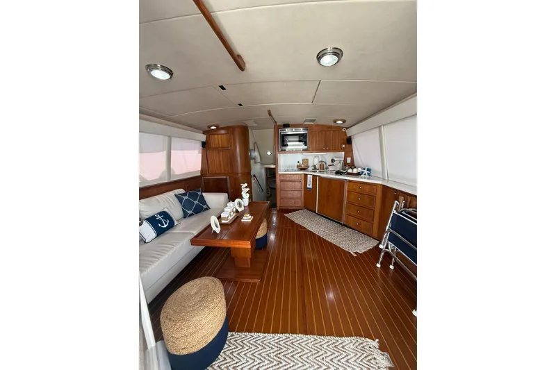 Slide: The Image of Luxurious interior of 1988 Bertram 43 Flybridge yacht with wooden finishes and modern amenities. - 26