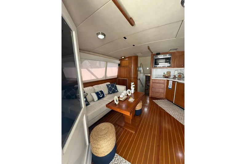 Slide: The Image of Interior of 1988 Bertram 43 Flybridge yacht with wooden furnishings and nautical decor. - 27