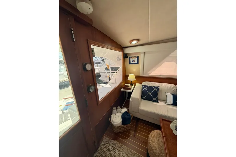 Slide: The Image of Interior of 1988 Bertram 43 Flybridge with cozy seating and nautical decor. - 29