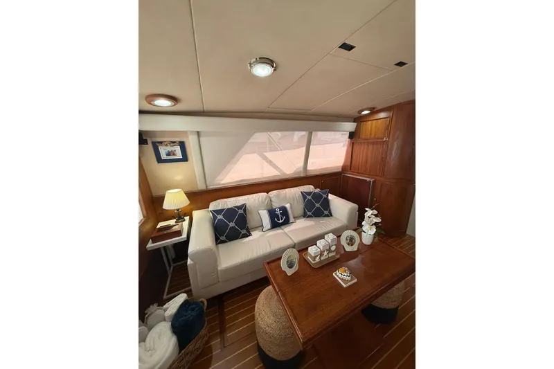 Slide: The Image of Interior of 1988 Bertram 43 Flybridge yacht with cozy seating and nautical decor. - 30