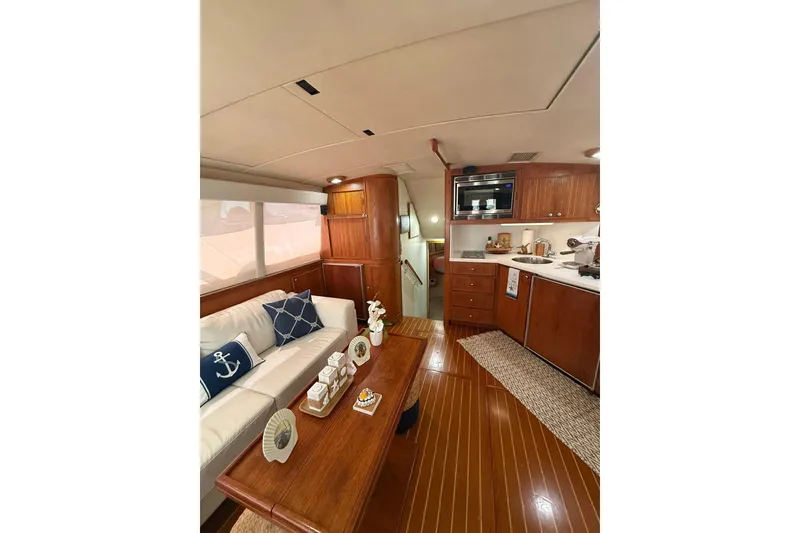 Slide: The Image of Luxurious interior of 1988 Bertram 43 Flybridge yacht with elegant wood finishes. - 31