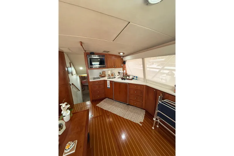 Slide: The Image of Interior of 1988 Bertram 43 Flybridge yacht with wooden cabinetry and modern amenities. - 32