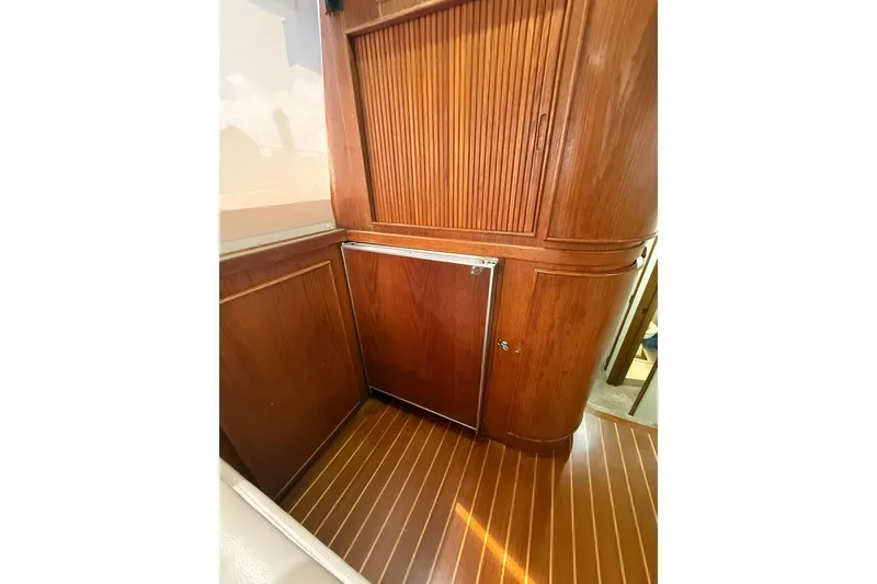 Slide: The Image of 1988 Bertram 43 Flybridge interior with wooden cabinetry and flooring. - 38