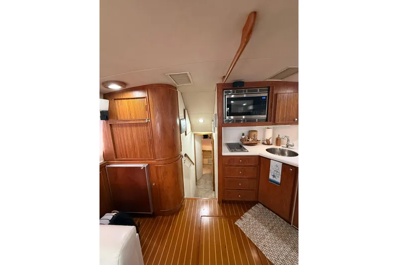 Slide: The Image of Interior of 1988 Bertram 43 Flybridge yacht with wood cabinetry and modern amenities. - 39