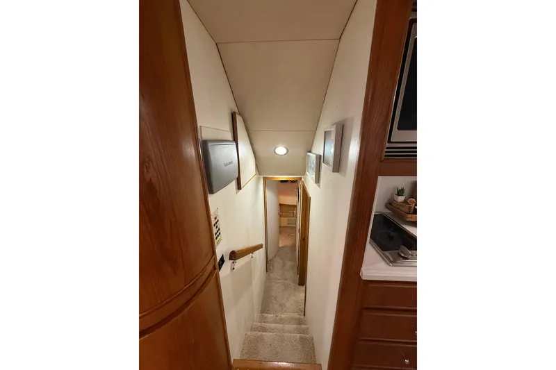 Slide: The Image of Interior view of 1988 Bertram 43 Flybridge yacht, showing stairs and hallway. - 40