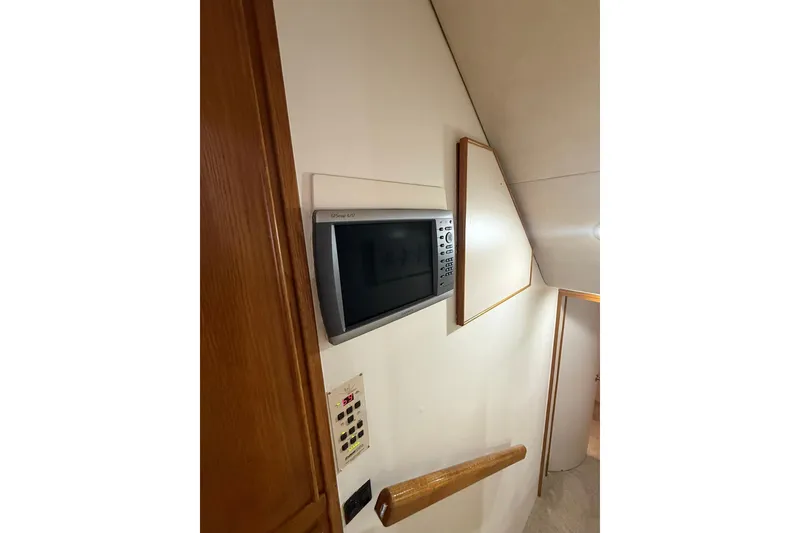 Slide: The Image of Microwave in 1988 Bertram 43 Flybridge yacht interior, mounted on a white wall. - 42