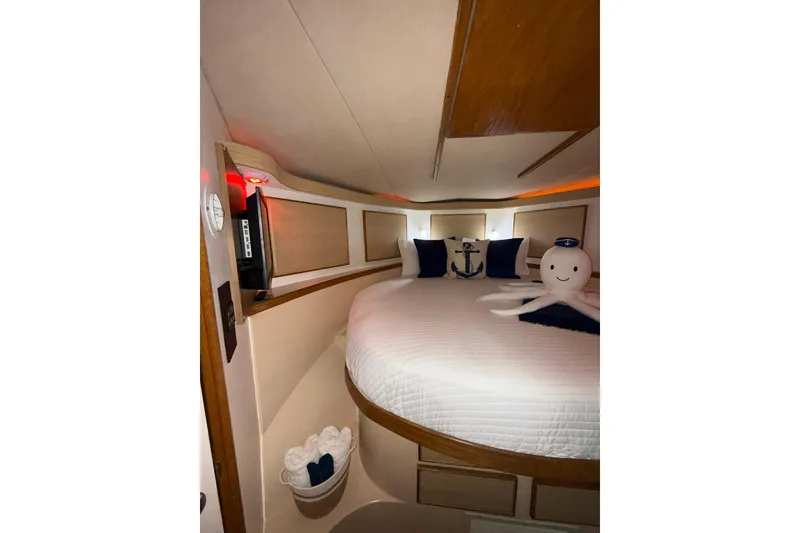 Slide: The Image of Cozy cabin interior of 1988 Bertram 43 Flybridge with nautical decor and plush bedding. - 47