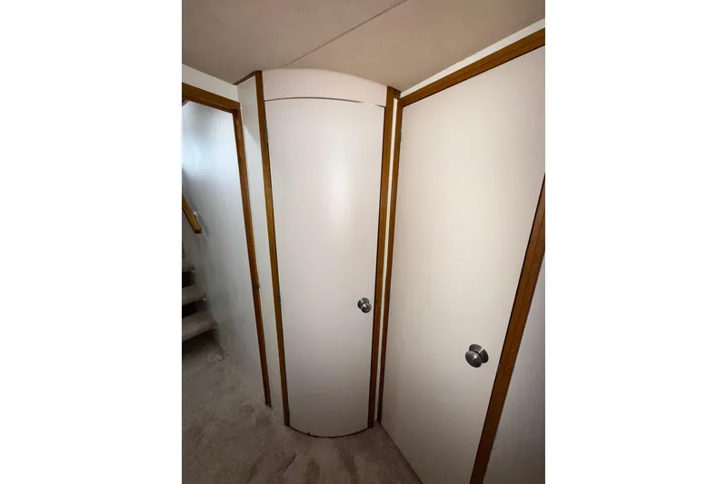Slide: The Image of Interior view of 1988 Bertram 43 Flybridge, featuring white doors and wooden trim. - 49