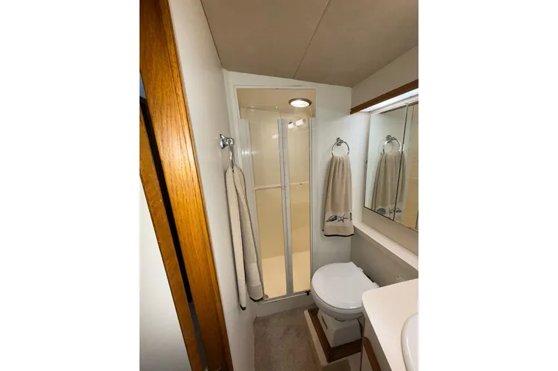 Slide: The Image of Bathroom interior of 1988 Bertram 43 Flybridge yacht with shower and toilet. - 51