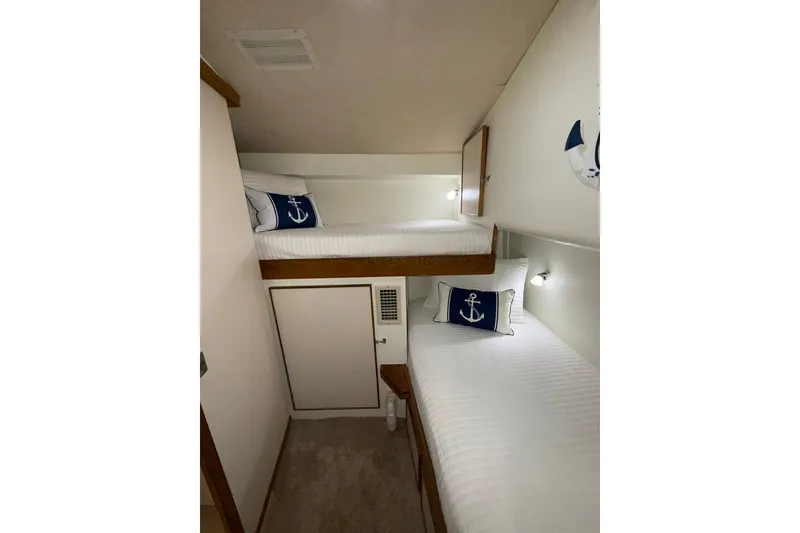 Slide: The Image of 1988 Bertram 43 Flybridge cabin with bunk beds and nautical-themed decor. - 53