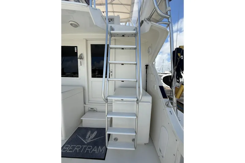 Slide: The Image of 1988 Bertram 43 Flybridge yacht with ladder and deck view. - 56
